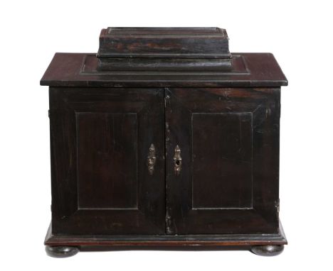 A FLEMISH EBONY TABLE CABINETLATE 17TH / EARLY 18TH CENTURYthe raised top with a sliding cover above a pair of doors enclosin