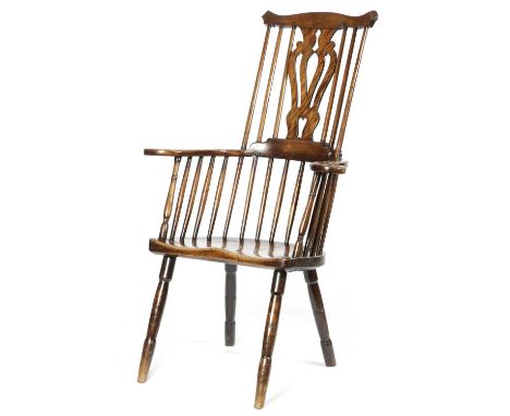 A FRUITWOOD COMB BACK WINDSOR ARMCHAIR19TH CENTURYwith a pierced vase shape splat with stick supports and scroll arms, above 