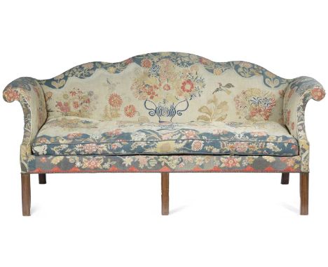 A MAHOGANY SERPENTINE SOFA IN GEORGE III STYLE, LATE 19TH / EARLY 20TH CENTURYwith tapestry needlework upholstery decorated w