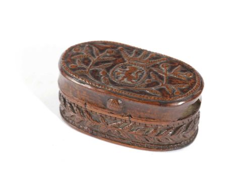 A TREEN SNUFF BOX 17TH CENTURYof oval form, the cover carved with a central crest of a lion rampant beneath a crown surrounde