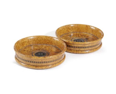 A PAIR OF TREEN BURR WOOD WINE BOTTLE COASTERS19TH CENTURYeach with a central ebony button and an inlaid band of lozenges to 