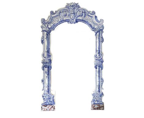 A DUTCH DELFT BLUE AND WHITE POTTERY TILE DOOR FRAMEPROBABLY LATE 18TH CENTURYcentred with a child's head mask beneath a bask