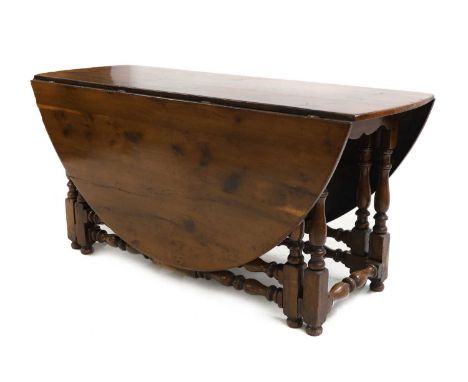 A yew wood gateleg table 17th century style, double gate action, on bobbin turned and stretchered legs,150cm wide60cm deep, 1