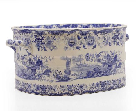 A Victorian earthenware jardinière of ovoid form with blue and white transfer decoration of shells, flowers and river landsca