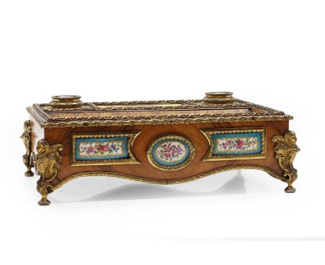 A Kingwood and gilt bronze mounted desk stand,  mounted with porcelain bleu celeste gilt and floral panels, the inkwell cover