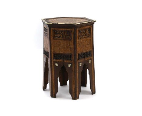 A Moorish hardwood hexagonal side table,  c.1900, inlaid and carved with Islamic script, with ivory edges, and pierced and tu