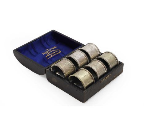 A cased set of six silver napkin rings, by Robert Pringle &amp; Sons, London 1905, each with chasing,4.5cm diametertogether w