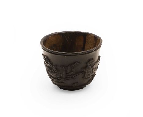 A Chinese coconut cup, 19th-20th century, of tapering form with a flared rim, carved with a continuous landscape of a garden 