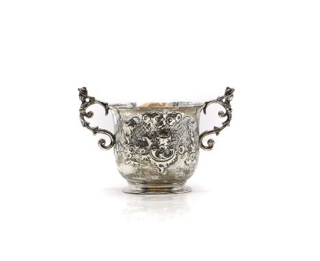 A George III silver loving cup London 1794, with chased decoration to a vacant cartouche, the handles modelled as ladies,14.5