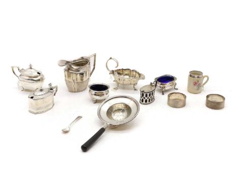 A collection of silver cruet items, to include two salts, three mustard pots, a minature silver mounted mug, 5cm high, a pair