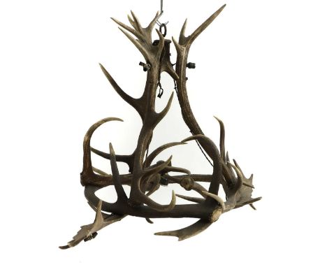 An antler seven-light chandelier early 20th century, formed of antlers in a concentric construction,100cm diameter76cm highCo