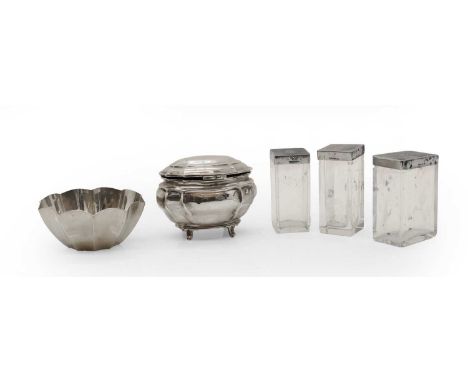 A group of silver dressing table items comprising a Tiffany bowl, marked Sterling, 10.5cm wide, three silver lidded jars, wit