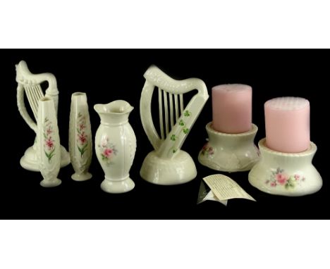 A collection of Donegal Belleek porcelain, various pieces decorated with pink flowers, to include two candle stands, a pair o