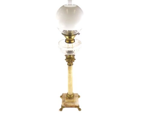 A late 19thC onyx and gilt metal oil lamp, with a later opaque glass globe shade and a clear reservoir, on a Corinthian colum