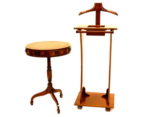 A walnut gentleman's valet stand, on shaped end supports and a reproduction drum table with leather top on turned column and 