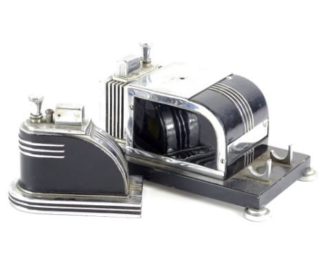 A Ronson Touch Tip Art Deco cigarette dispenser, with black enamel finish to the chrome plating containing a lighter on turne