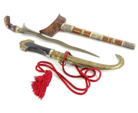 A Malayan Kris, with hardwood and silver coloured metal, scabbard, elaborately shaped blade and wooden handle, 46cm long, and