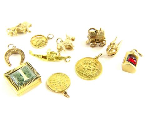 A group of 9ct gold and other charms, comprising a 9ct gold miners lamp, set with red cabochon stone, a 9ct gold swan balleri