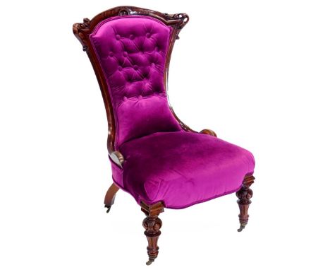 A Victorian mahogany show framed nursing chair, upholstered in vivid purple button velvet, on part turned and fluted legs wit