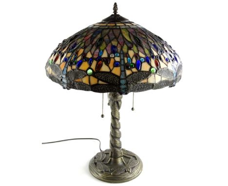 A Tiffany style lamp, the leaded shade decorated with glass cabochon dragonflies etc., on a twisted column and dragonfly cast