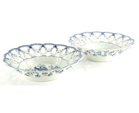 A pair of 19thC Worcester type porcelain baskets, each printed in blue with pine cones, flowers, etc., within pierced borders