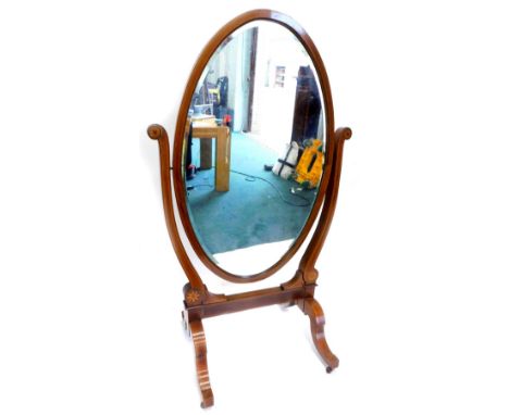 A late 19thC Sheraton revival mahogany cheval mirror, with circular bevelled plate on 'U' shaped supports, headed by a patera