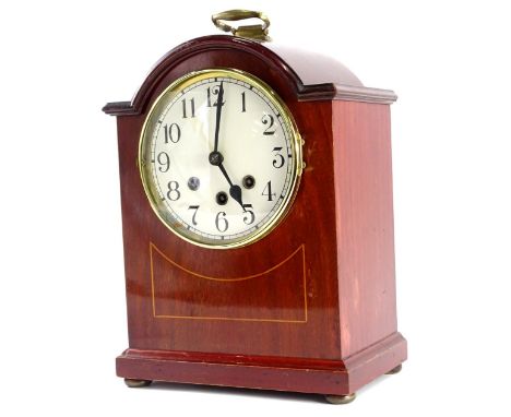 An early 20thC mahogany and boxwood strung mantel clock, with Westminster chime, the white dial with Arabic numerals and with