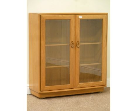 Ercol light elm bookcase enclosed by two glazed doors fitted with two adjustable glass shelves, W92cm, H97cm, D32cm