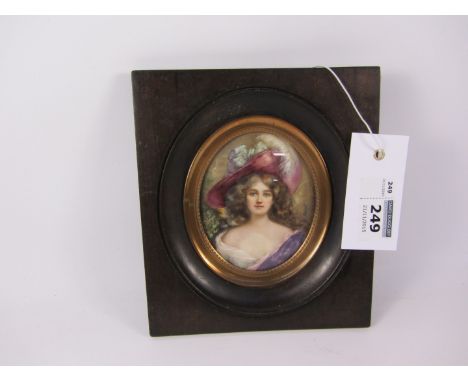 Early 20th century portrait miniature of a lady in pink and purple signed Regnol