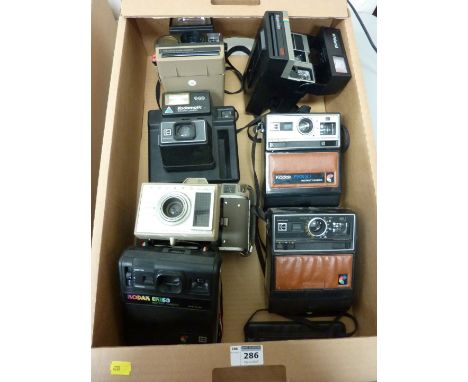 Seven Vintage Polaroid Cameras in one box.