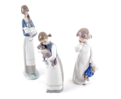 Three Lladro figures, comprising a girl carrying lamb, child carrying lamb, and a Nao child with clown teddy bear. (3) 