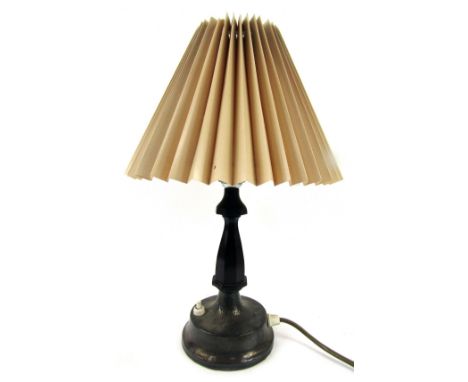 A table lamp, with an Arts and Crafts silver foot, marks indistinct with brown Bakelite stem and a fluted cream shade, 35cm h