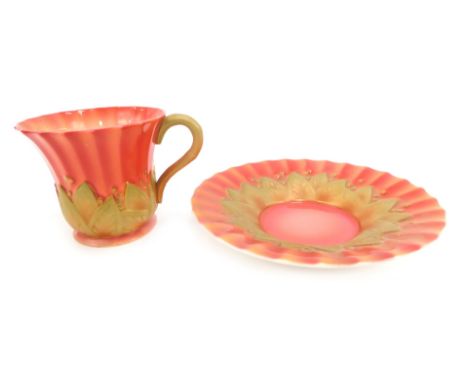 A Royal Worcester porcelain coffee cup and saucer, circa 1934, of fluted and leaf moulded form, shape number 3061, printed Re
