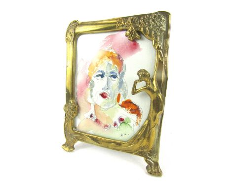 An Art Nouveau style brass photograph frame, of rectangular form with applied semi clad female motif, flowers and lilies, ins