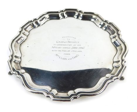 A George V silver salver, with fluted border, on tripod base, inscribed Presented to George Briarly in Commemoration on His F