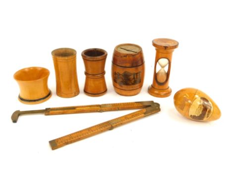 A group of treen, comprising a Leamington Spa egg cup, a treen dice shaker, egg timer, Forth Bridge Switzerland money bank ba