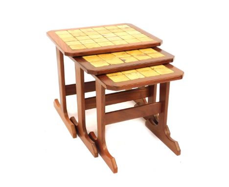 A G-Plan teak nest of occasional tables, with inset tile tops, the largest 44cm high, 450cm wide, 43cm deep. 