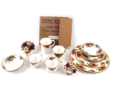 A Royal Albert Old Country Roses part tea service, comprising three teacups one coffee cup, two floral posy groups, two large