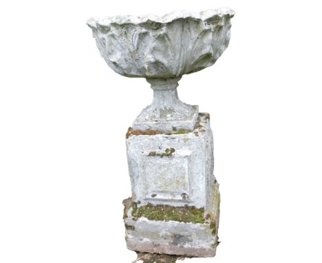 A reconstituted stone planter, the circular fluted bowl on a columned base, 89cm high, 52cm wide. 