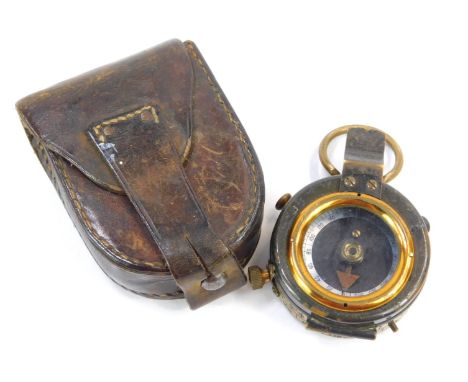 A Military pocket compass, with brass outer casing, with military arrow stamped X692, 7cm high, in leather carry case. 