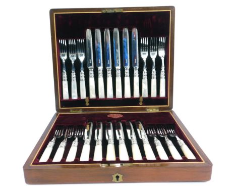 A set of late Victorian silver plated dessert knives and fork, with mother of pearl handles, in a fitted walnut case with red