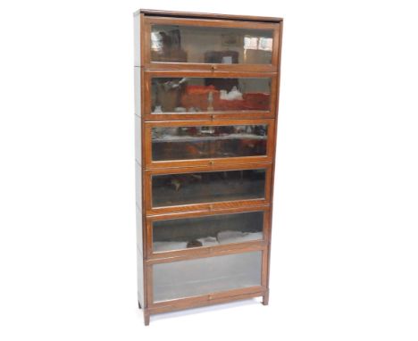 A Globe Wernicke style oak six section bookcase, with glazed up and over doors, raised on square feet, 186.5cm high, 87cm wid