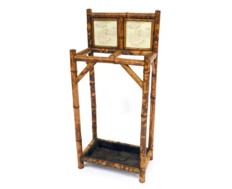 A Victorian bamboo stick and umbrella stand, with a later tile back and metal drip tray, 87cm high, 39cm wide, 24.5cm deep. 