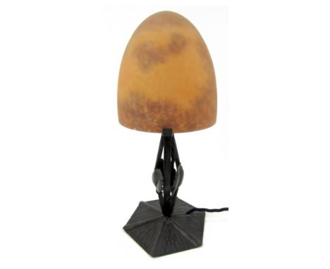 A Daum style table lamp, with a domed orange mottled glass shade, on a metal leaf moulded base, 29cm high. 