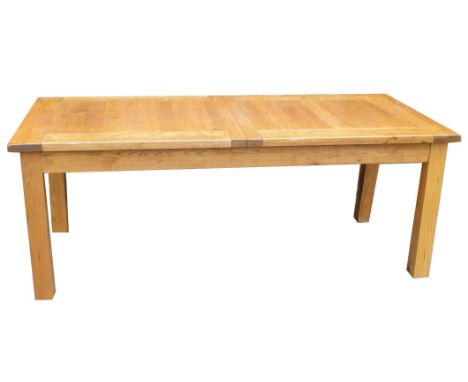 A light oak draw leaf dining table, with two additional half leaves, raised on square legs, 77cm high, 204cm wide, 270cm exte