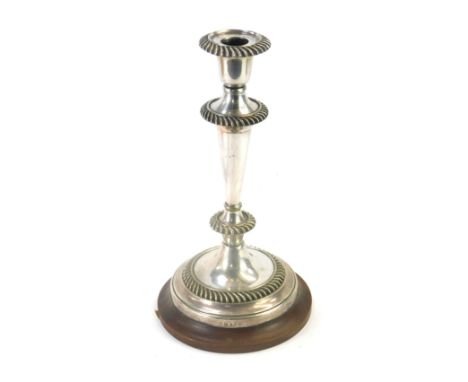 A late 19thC Elkington and Co silver plated candlestick, on a turned wooden base, 27cm high. 