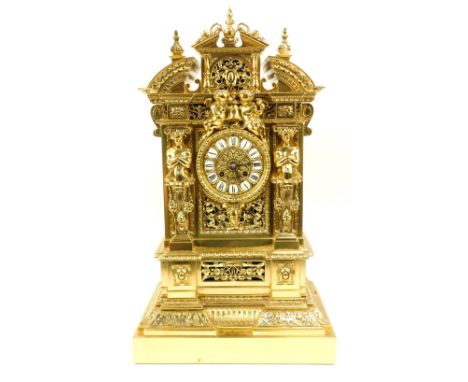 A French gilt brass mantel clock, the case decorated with swags, pillars and cherubs, above circular dial with Roman numeric 