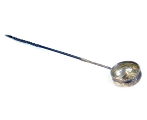 A George III silver toddy ladle, unmarked, with ogee bowl set coin centre and legend to the rim, with twisted whale bone hand