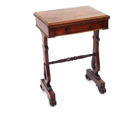 A late Regency mahogany fold over card/work table, with a red tooled Morocco top, over a frieze drawer, raised on lyre end su