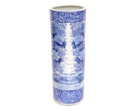 An early 20thC Japanese blue and white stick stand, of cylindrical form with blue and white spray of animals and storks, 61cm